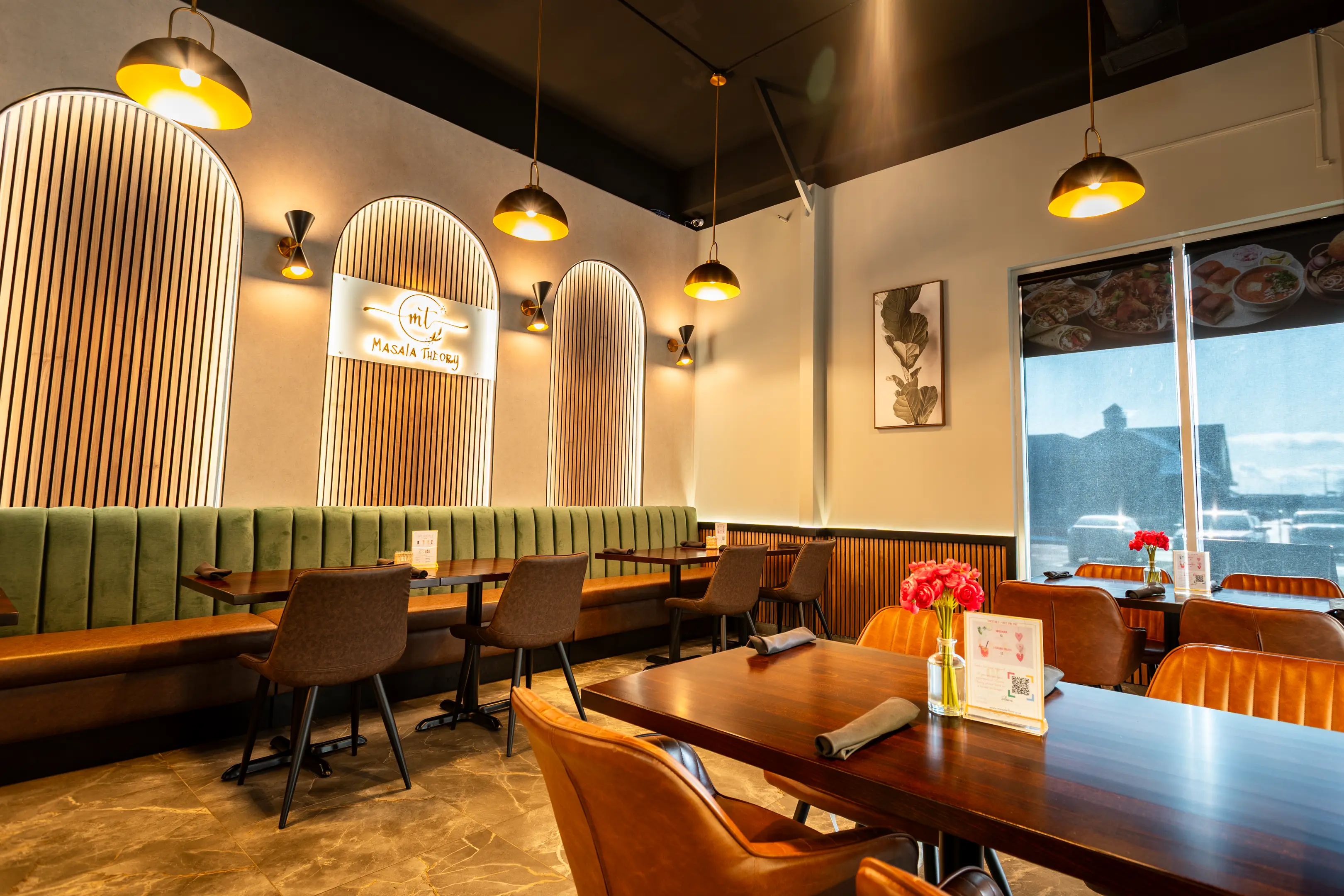 Green booth seating under the Masala Theory sign in Calgary SE