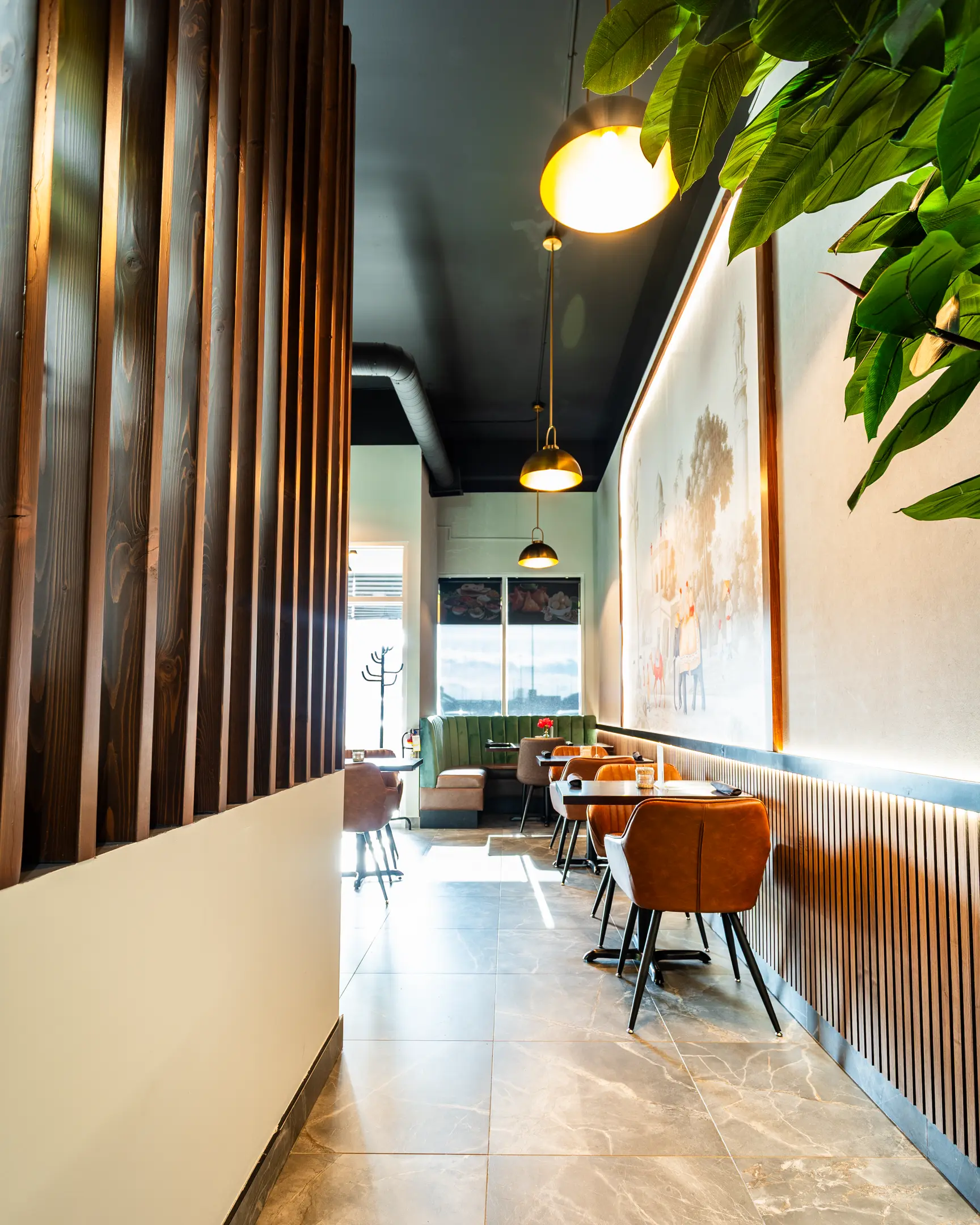 Dining room aisle with booth seating at Masala Theory Indian Bistro Calgary SE