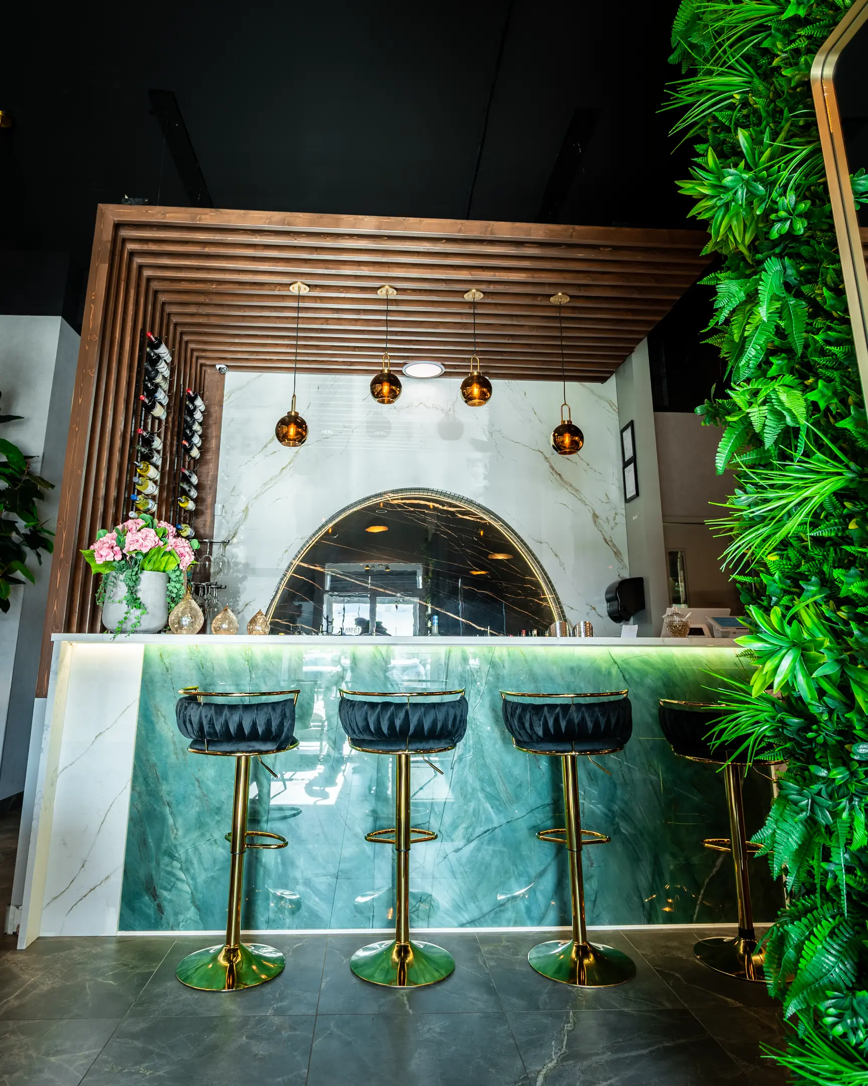 Full bar with green marble counter and wine rack at Masala Theory Calgary SE
