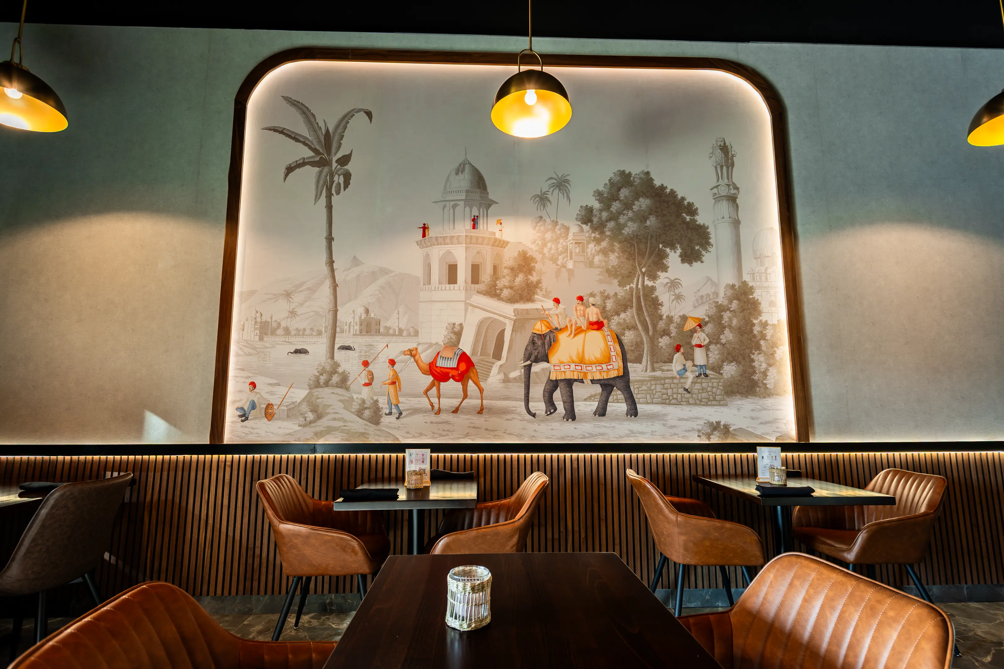 Hand-painted Indian mural of elephants and camels inside Masala Theory Calgary